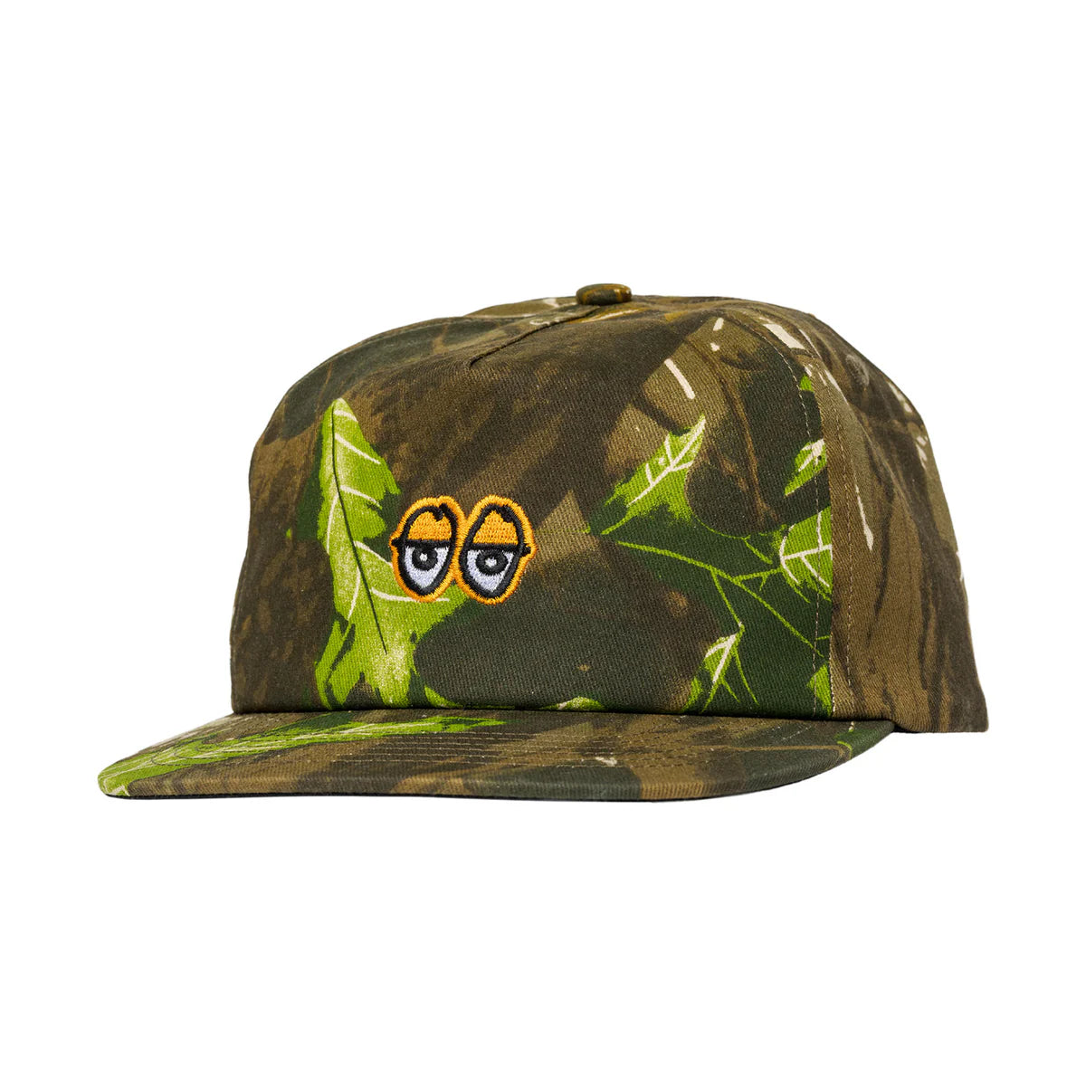 Camouflage cap with leaf pattern and cartoon eyes on a white background