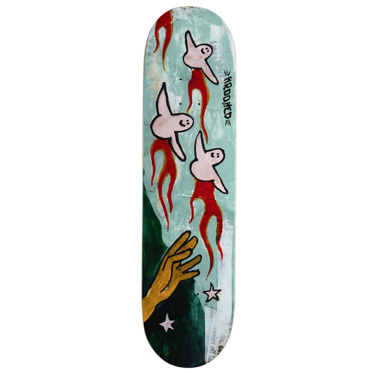 A skateboard deck featuring a surreal painted design with three pale pink birds with red tails, a gold hand reaching down, and white stars on a light teal and dark green background. The brand name 'krooked' is printed vertically on the side.