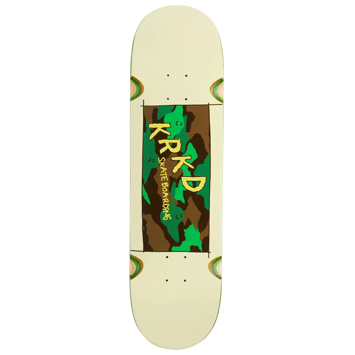 A skateboard deck shown from the underside, featuring a cream-colored base with a central graphic containing a green and brown camouflage pattern, yellow Japanese katakana text, and small green and yellow circular accents near the corners.
