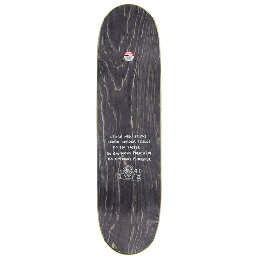 A skateboard deck shown from the underside, featuring a dark wood grain pattern in black and dark brown tones with white handwritten text and a small red, white, and blue logo near the top edge.