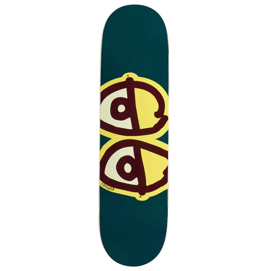 A skateboard deck shown vertically against a plain white background. The deck has a dark teal-green base with a large graphic in the center featuring two stylized eyes in yellow, cream, and dark red/brown.