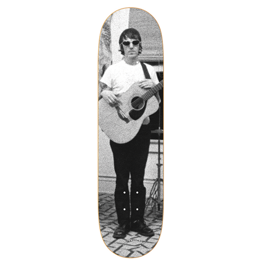 Skateboard deck with a black and white photo of a person playing guitar on a white background