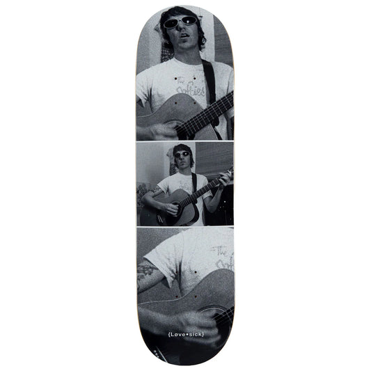 Skateboard deck with a collage of a person playing guitar, featuring the brand 'Love Sick'.