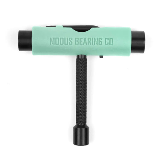 T-shaped tool with green handle and black ends on a white background