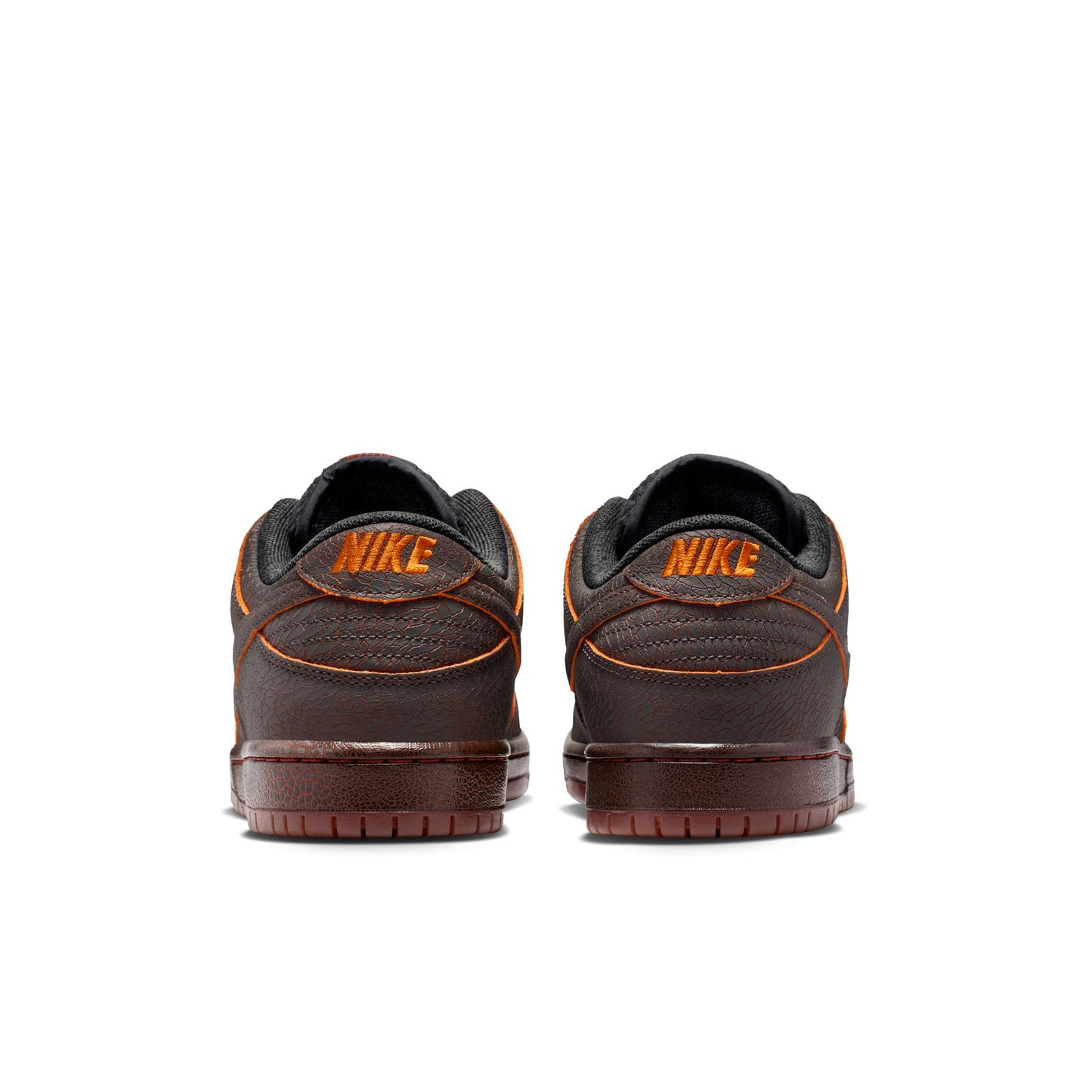 Brown Nike sneakers with orange accents on a white background
