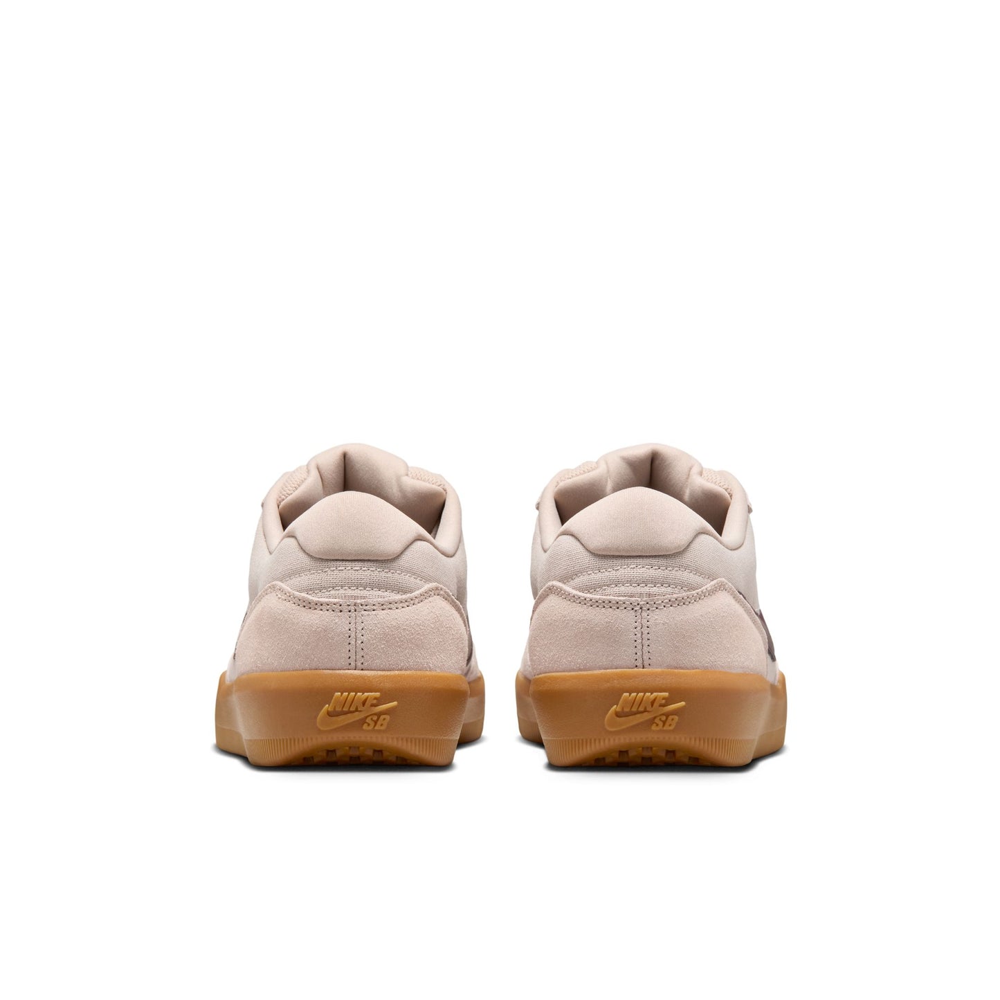 Pair of beige sneakers with brown soles on a white background