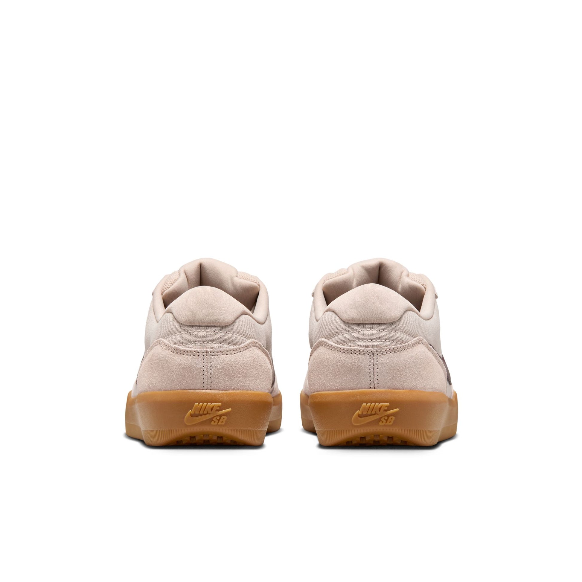 Pair of beige sneakers with brown soles on a white background