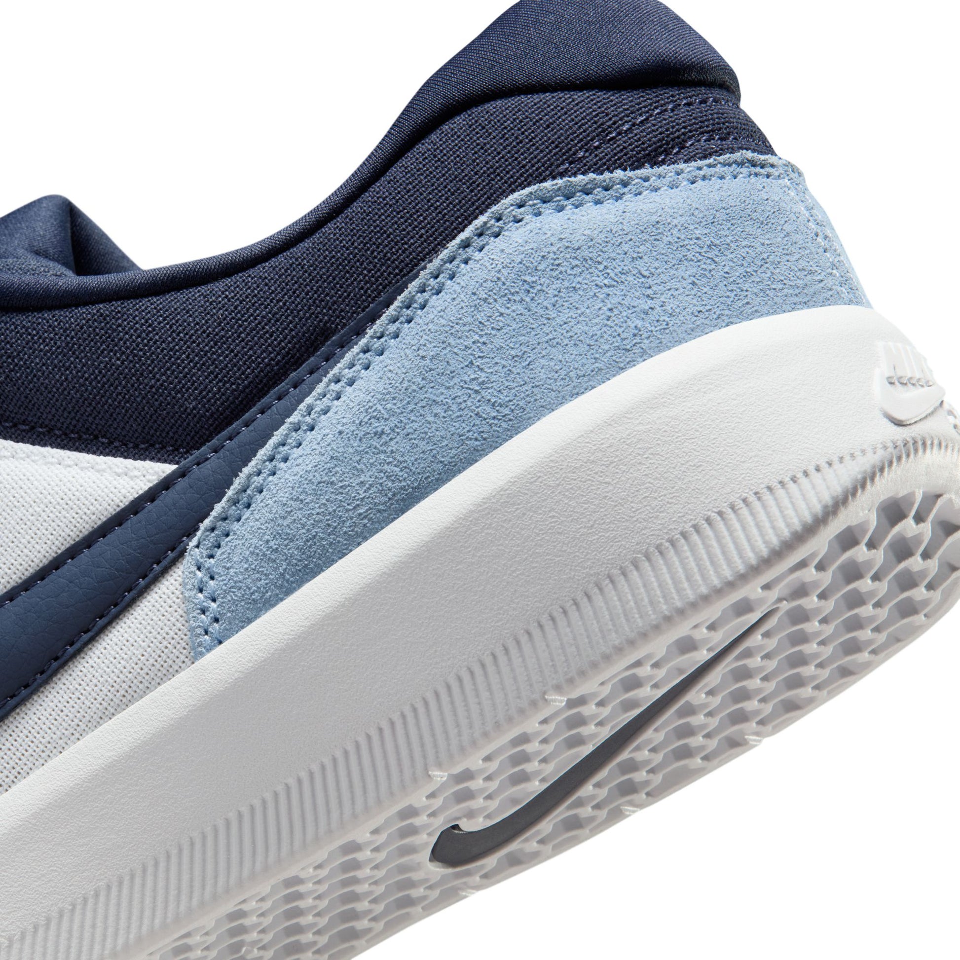 Close-up of a sneaker with blue and gray design on a white background