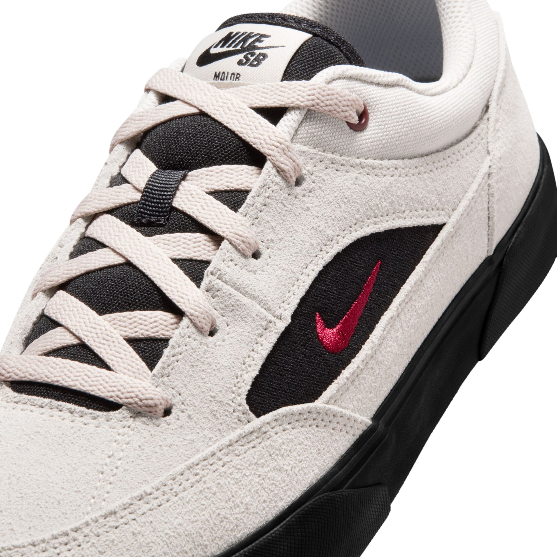 White sneaker with black and red accents featuring Nike SB logo on a white background