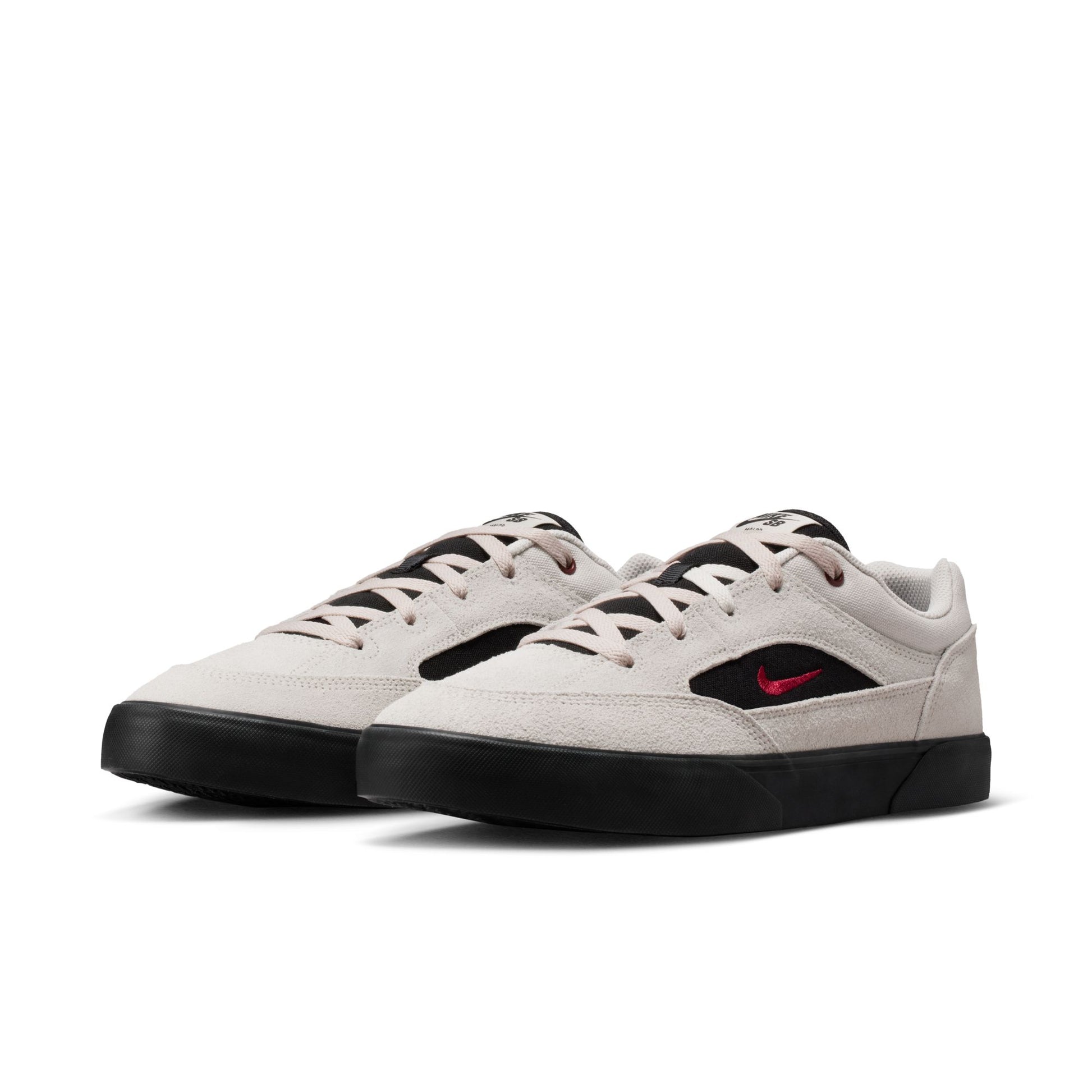 White sneakers with black soles and a red logo on a white background