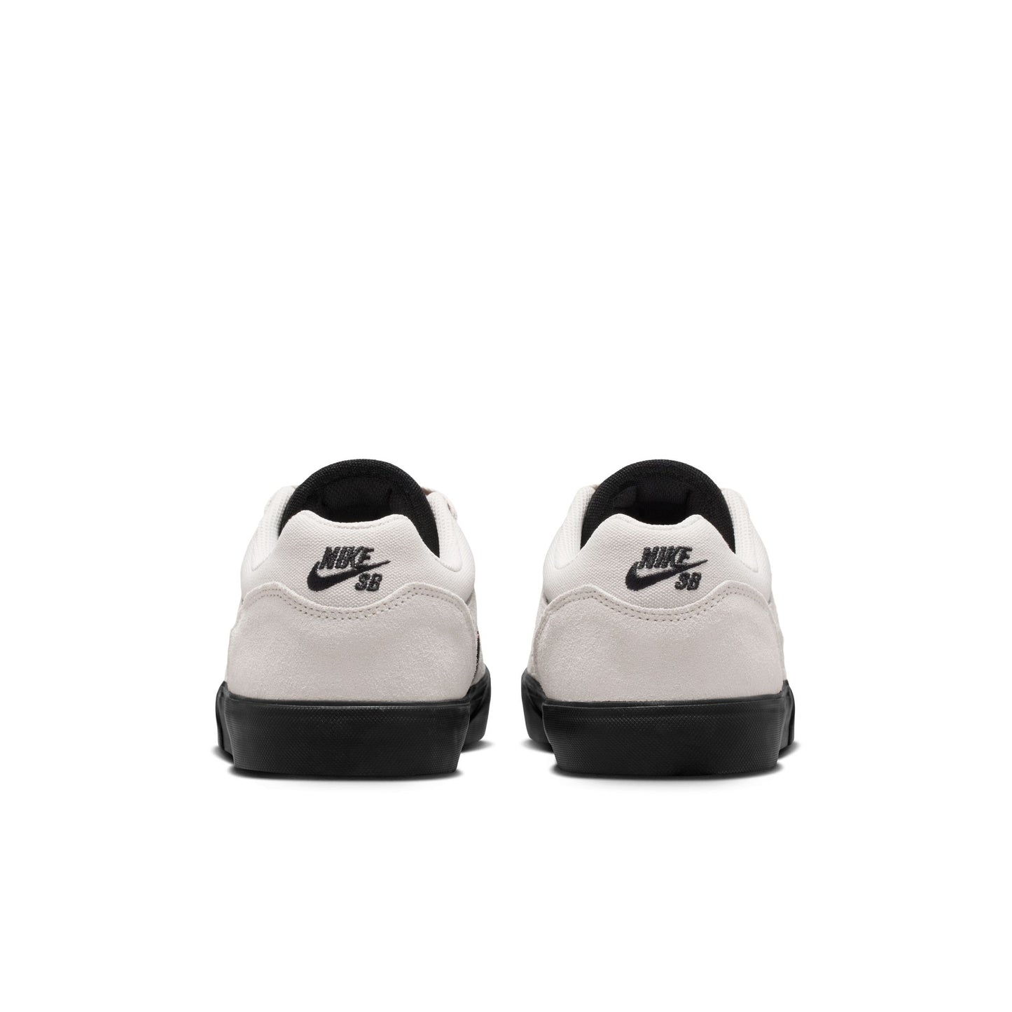 White sneakers with black soles and Nike SB logo on a white background