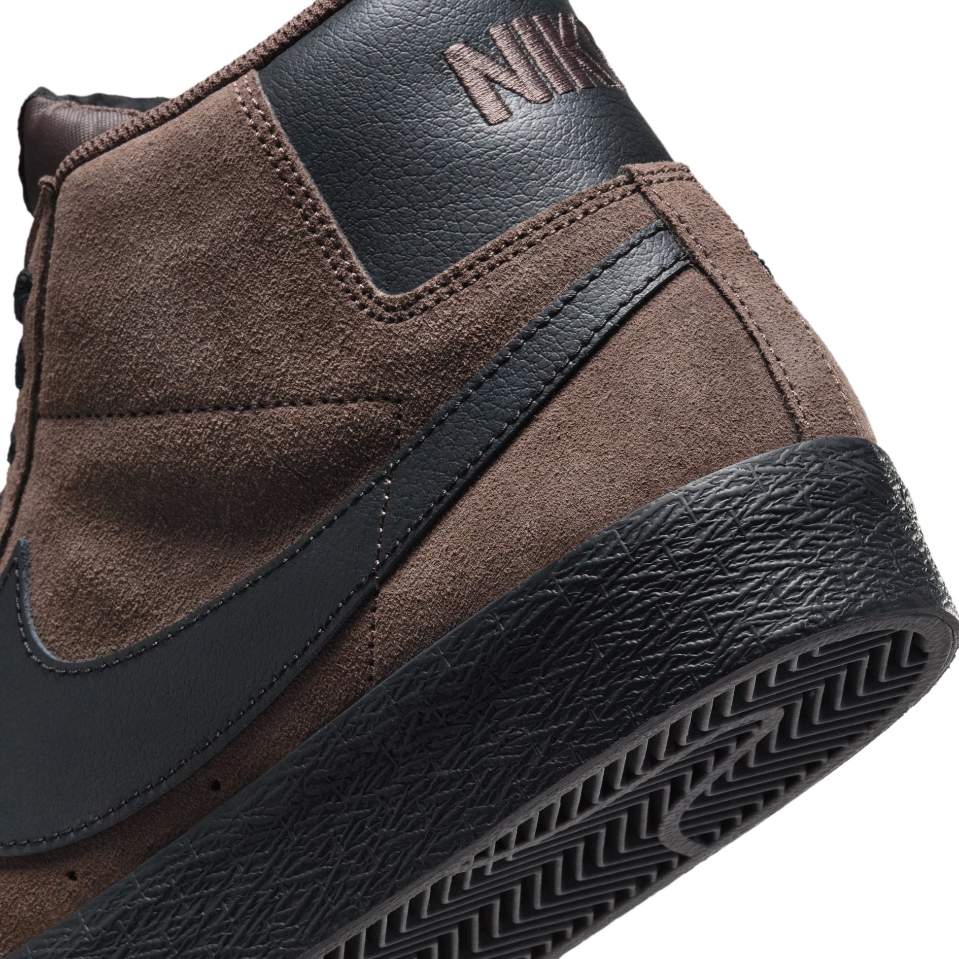 Brown and black sneaker with Nike logo on a white background