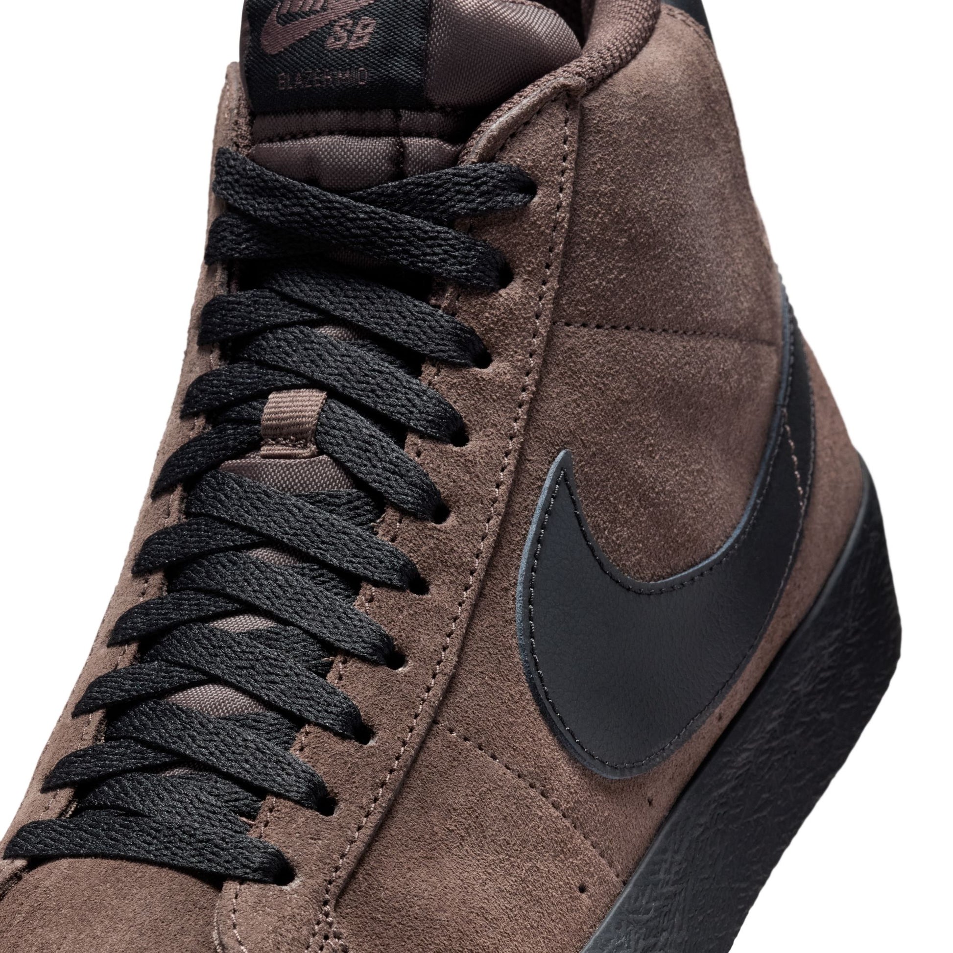 Brown sneaker with black laces and Nike logo on a white background