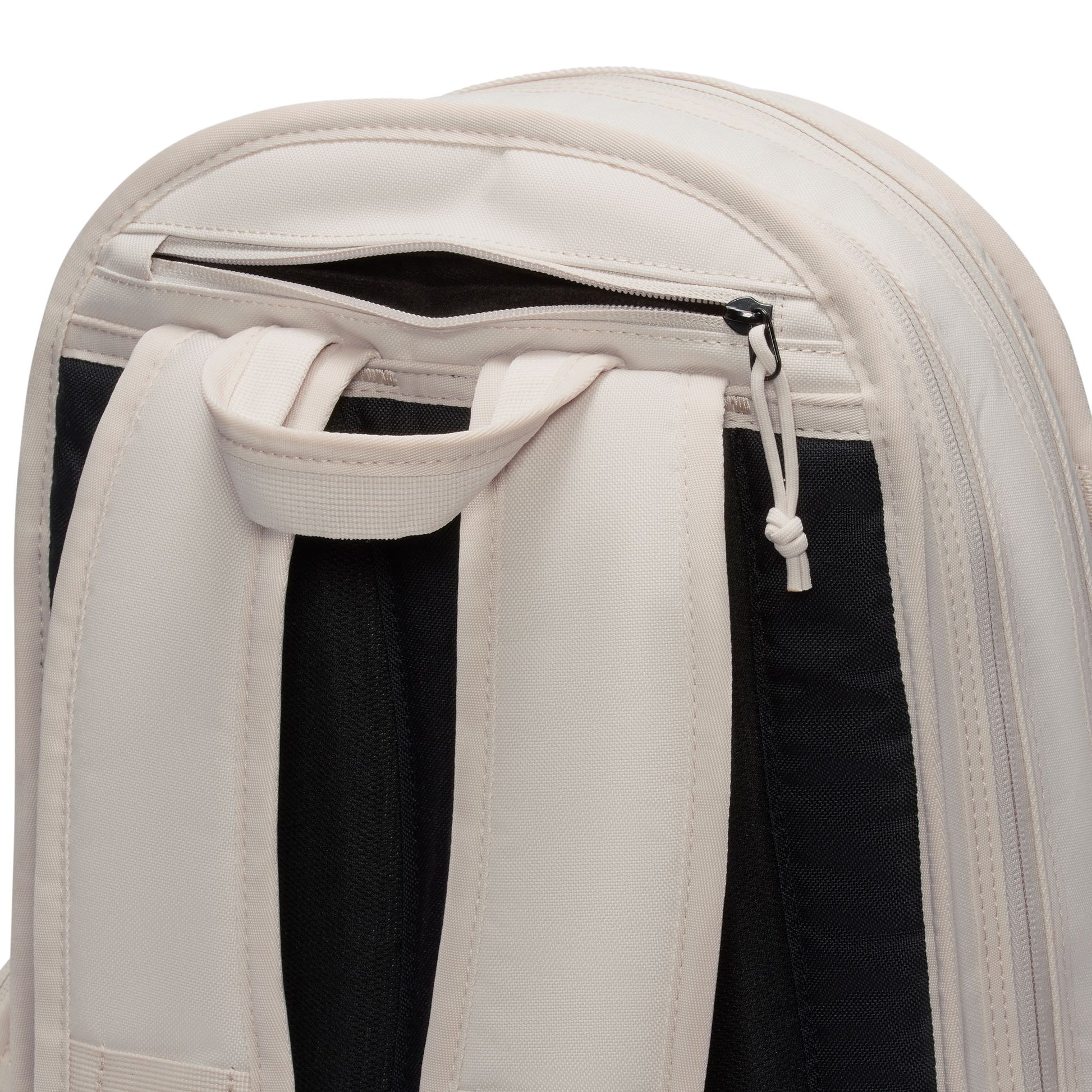 Close-up of a beige backpack with a drawstring pocket on a white background
