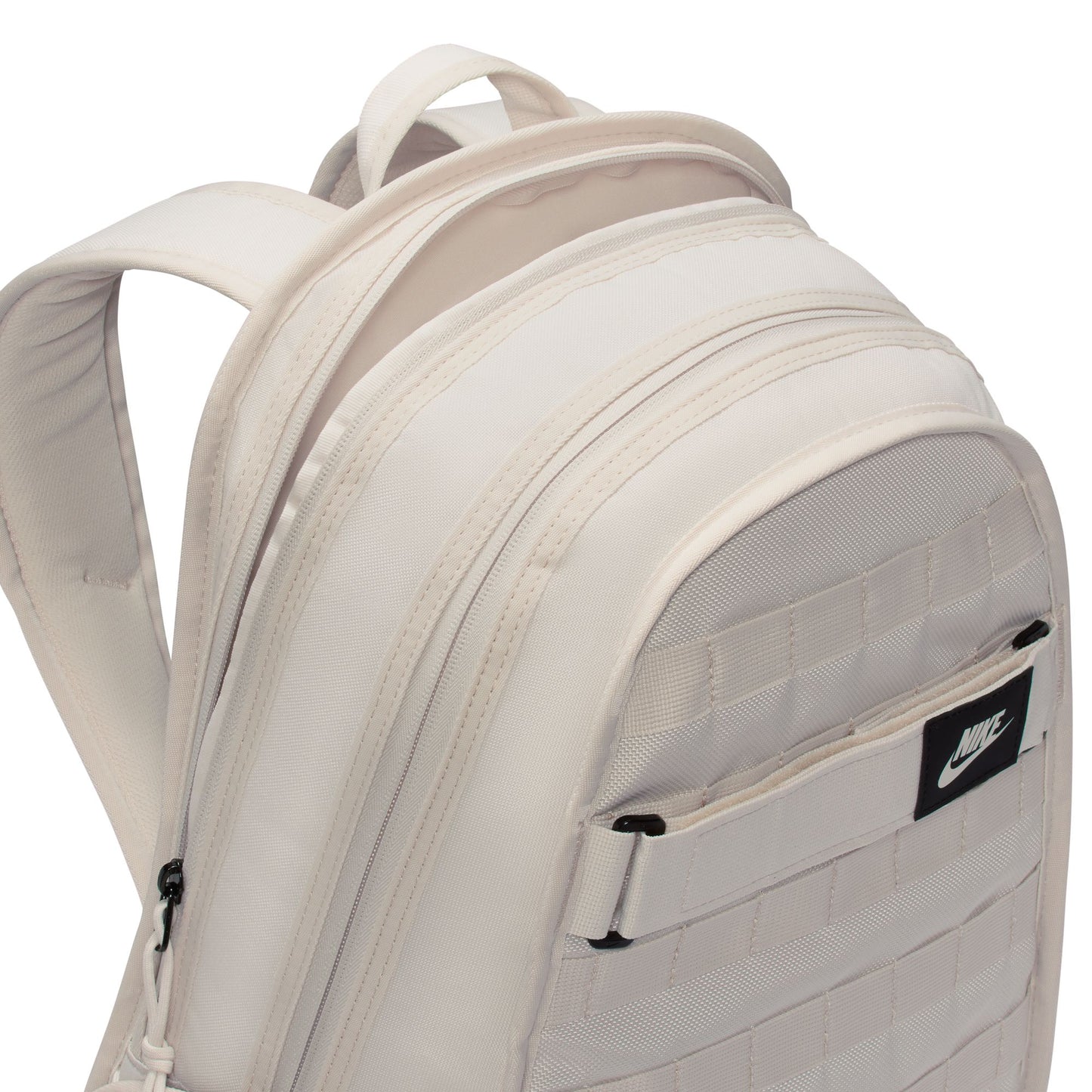 Beige backpack with a Nike logo on a white background
