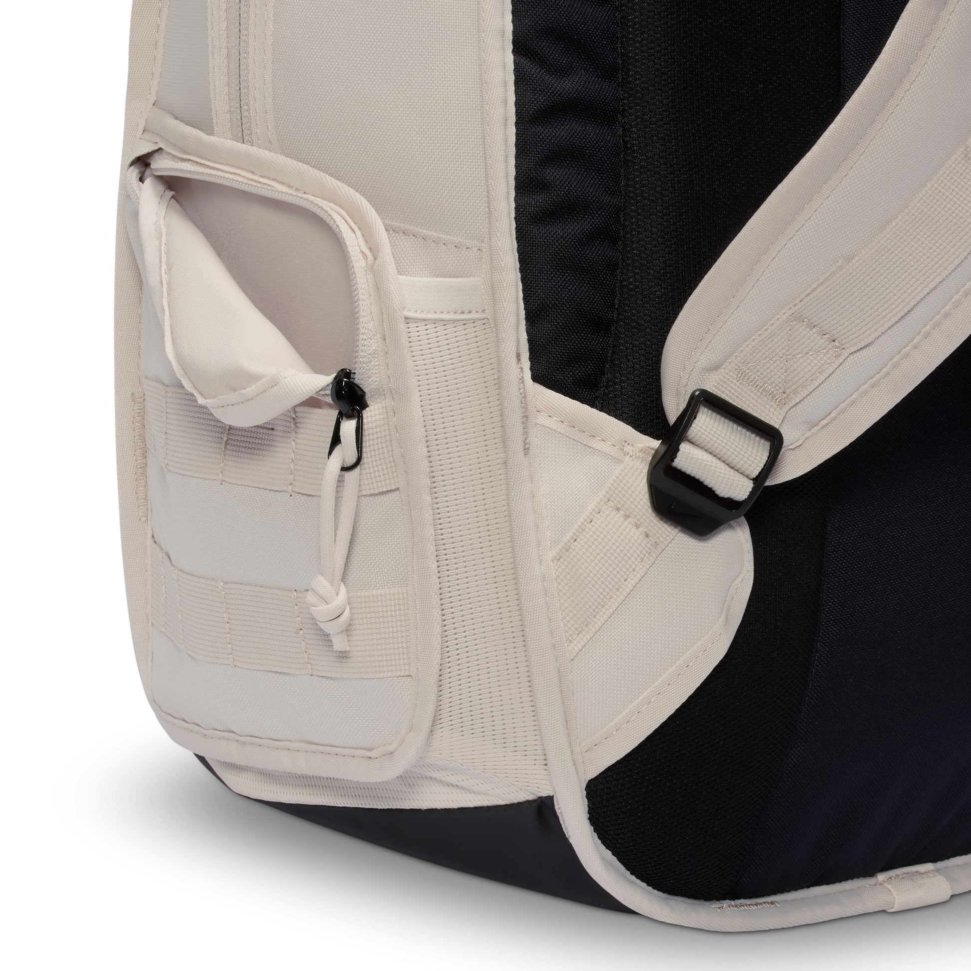 Close-up of a beige backpack with a black interior on a white background