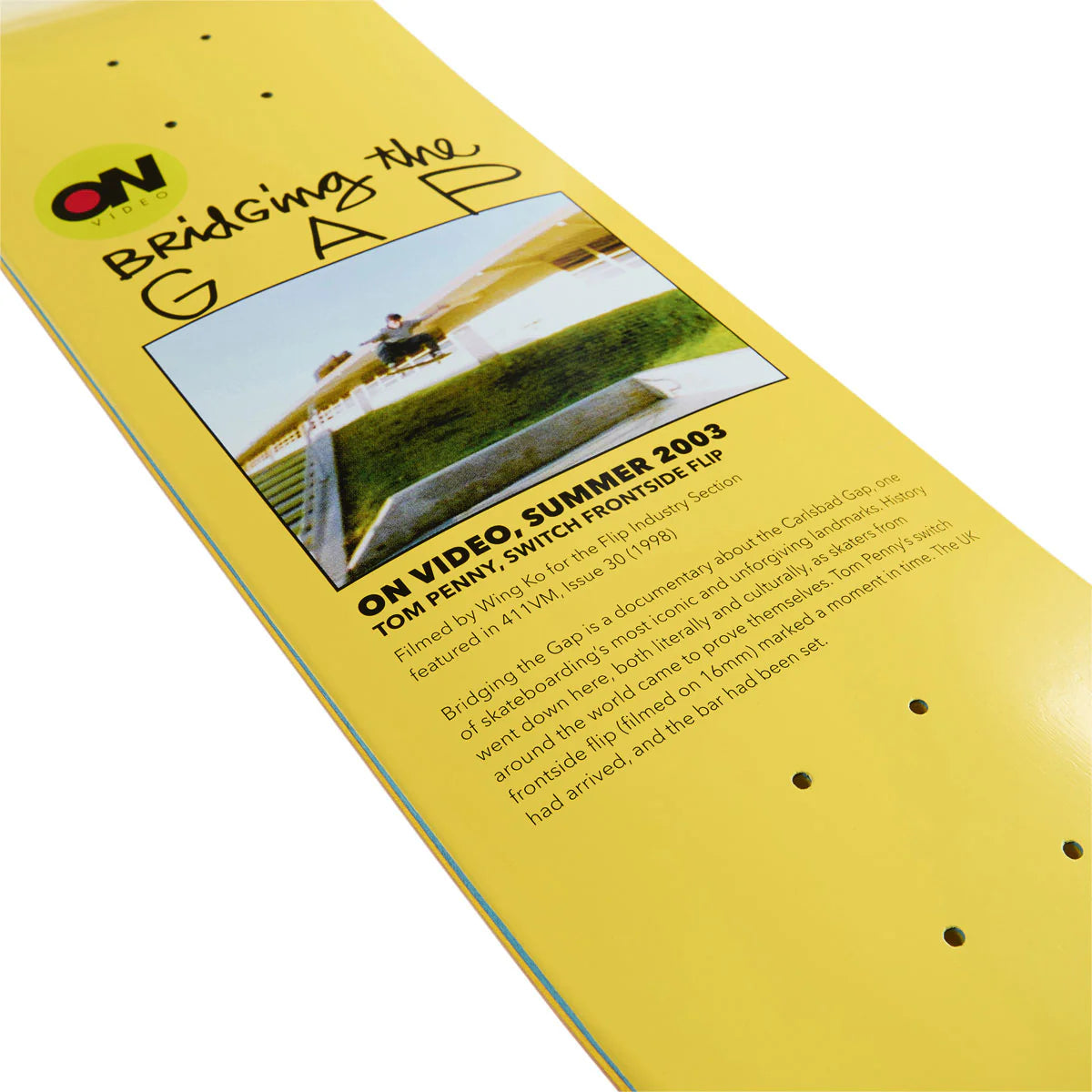 Yellow skateboard deck with text and a photo of a person on a bike, featuring the brand 'ON'.