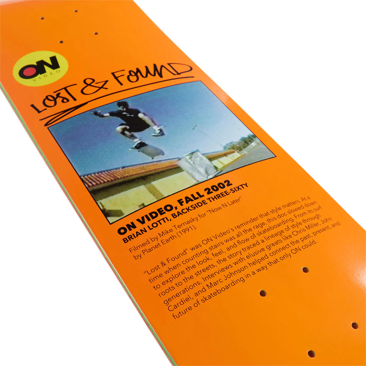 Orange skateboard deck with 'Lost & Found' graphic and text on a white background