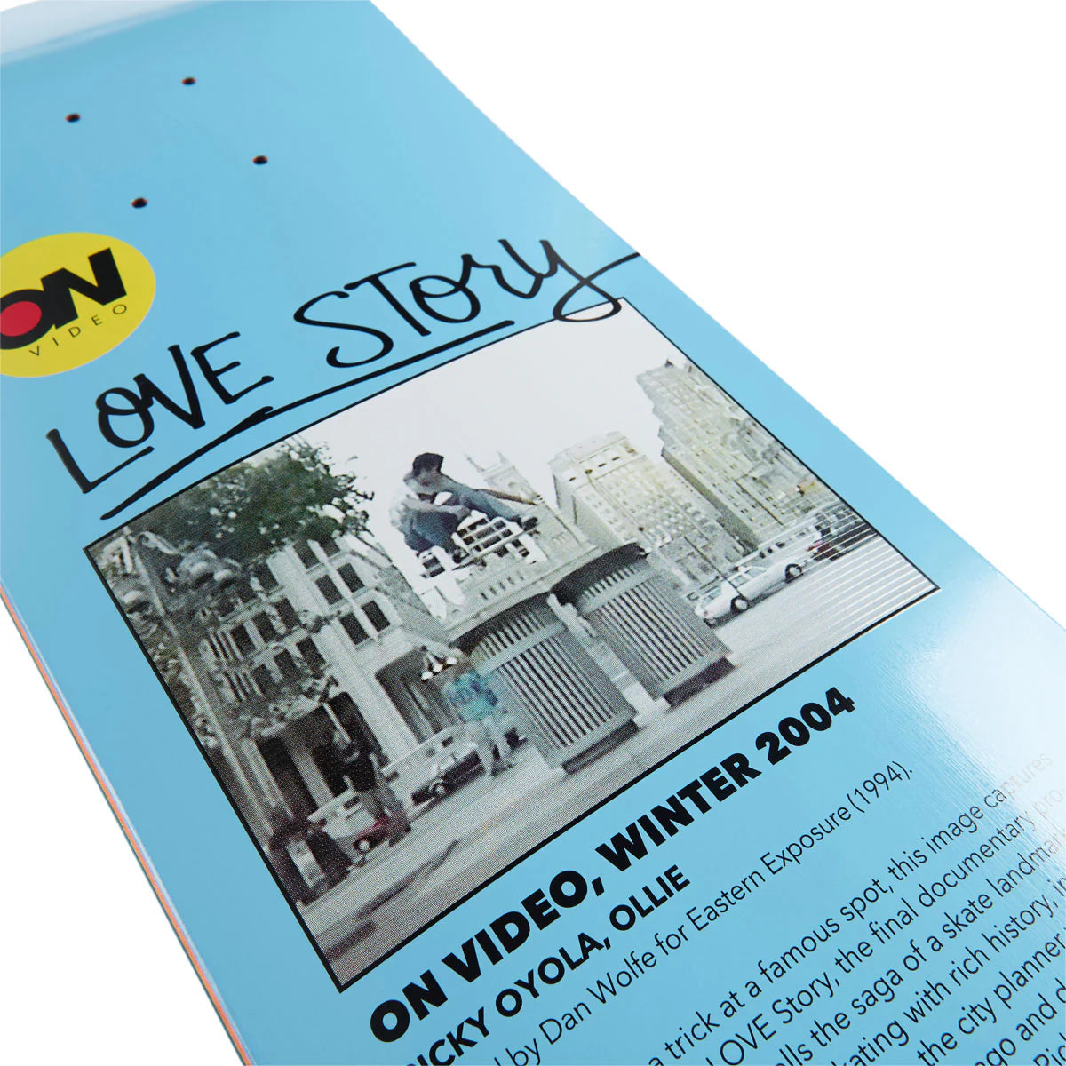 Skateboard deck with 'Love Story' design and text on a blue background