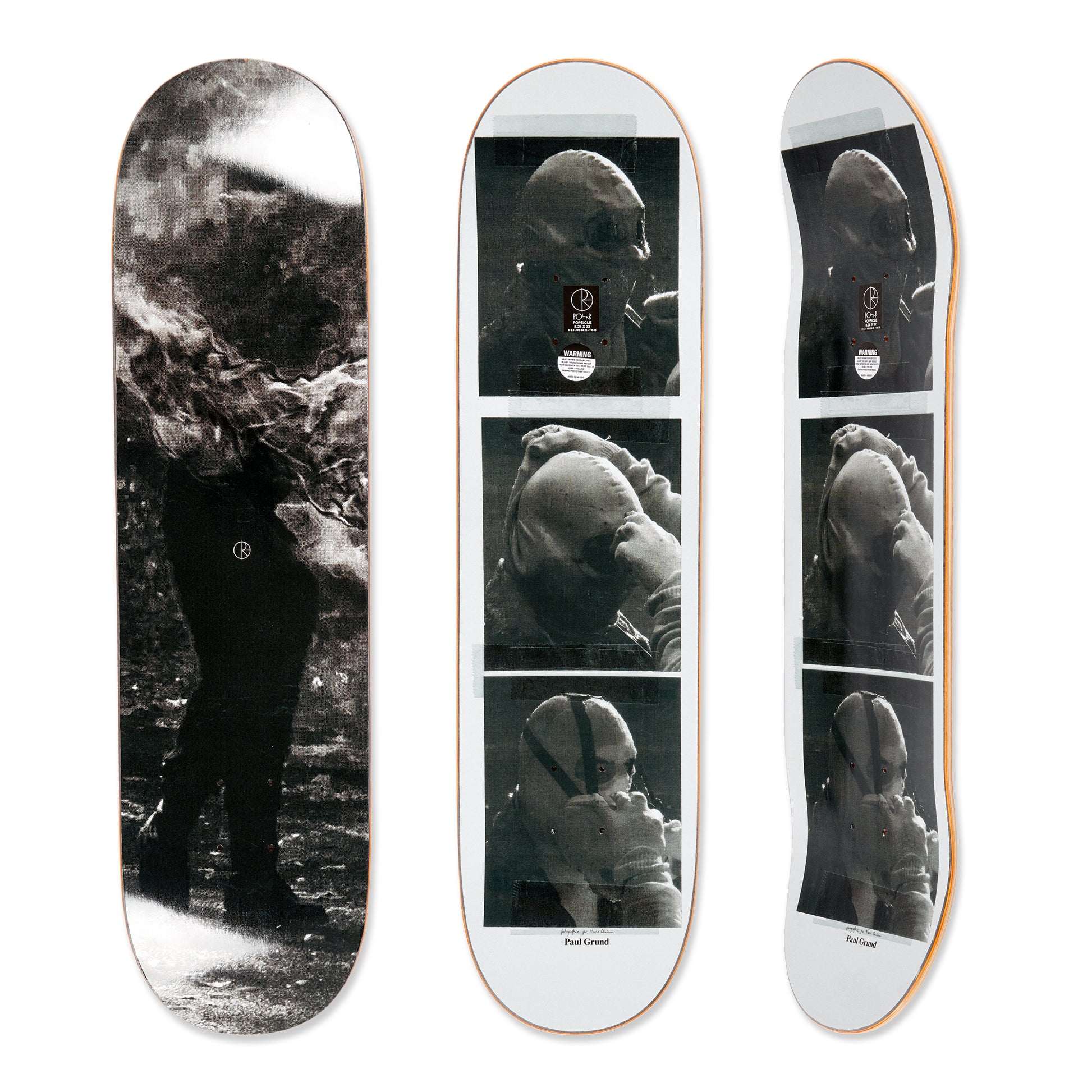 Three skateboard decks with black and white images of a person underwater.