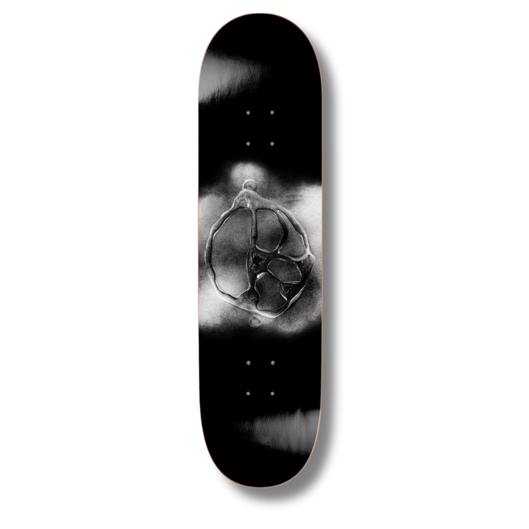 Skateboard deck with black and white design on a white background