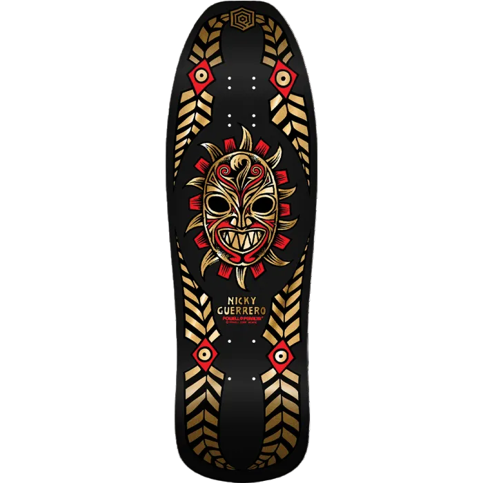 Skateboard deck with a tribal mask design on a black background
