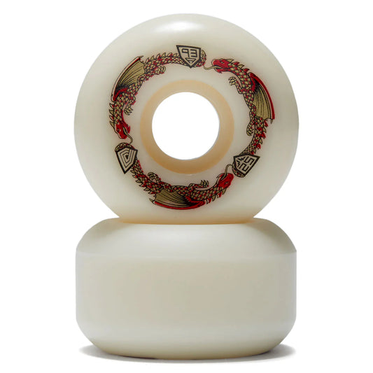 Two white skateboard wheels with decorative patterns on a white background