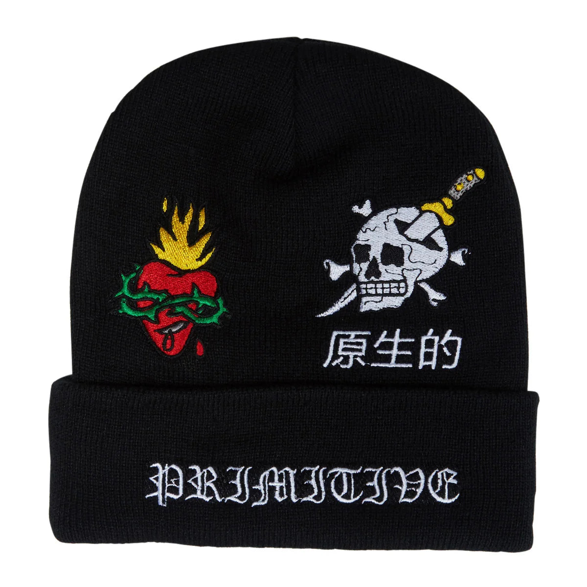 A black knit beanie hat featuring embroidered graphics: a red and green heart with yellow flames on the left, a white skull and crossbones with a yellow knife on the right, white Japanese characters below, and the word 'PRIMITIVE' in white gothic lettering on the folded cuff.