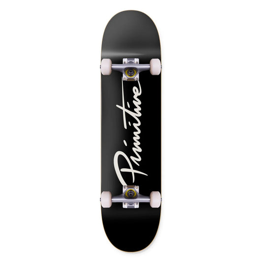 A black skateboard deck with a white 'Primitive' logo printed vertically on the underside, shown against a plain white background.