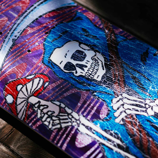 Colorful skateboard deck with skeleton design and abstract patterns