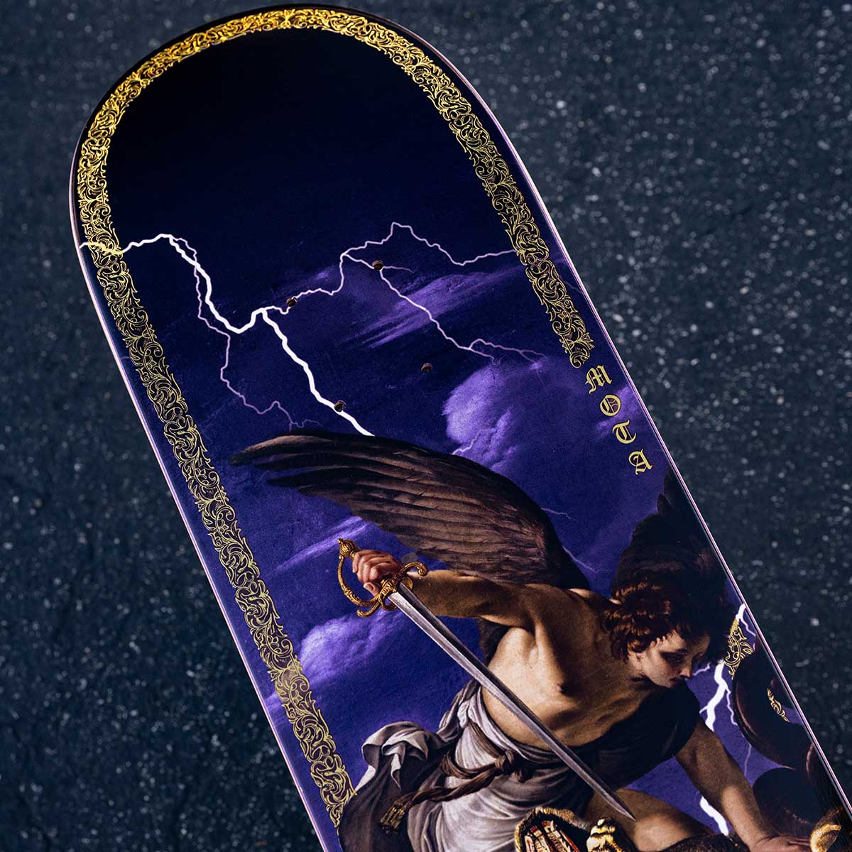 Skateboard deck with angel design against a dark background