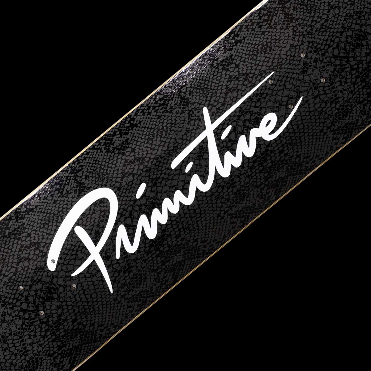 Black skateboard deck with 'Primitive' logo on a black background