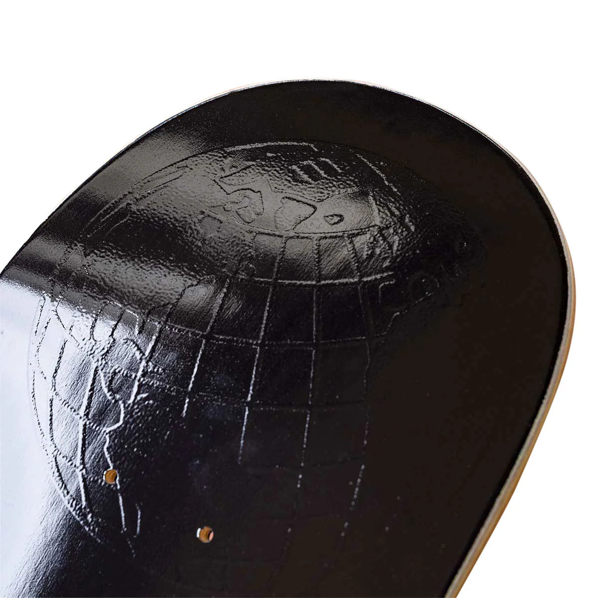 Close-up of a black skateboard deck with embossed design on a white background