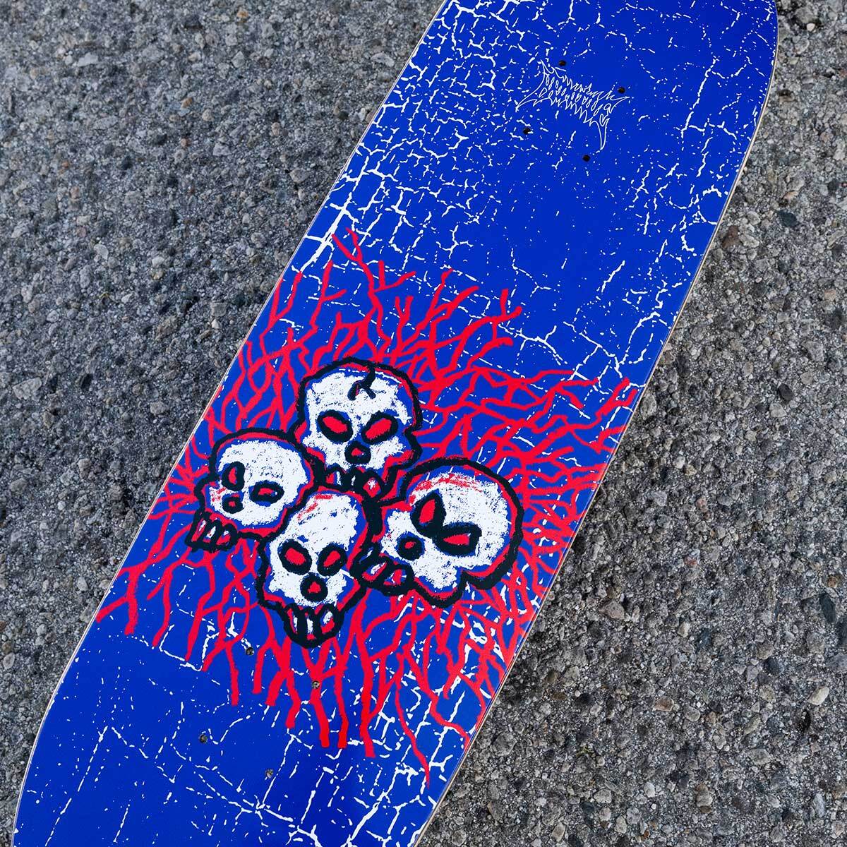 Skateboard deck with skull design on a textured surface