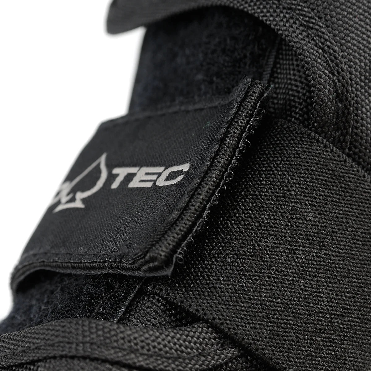 Close-up of a black wrist guard with a brand logo on a white background