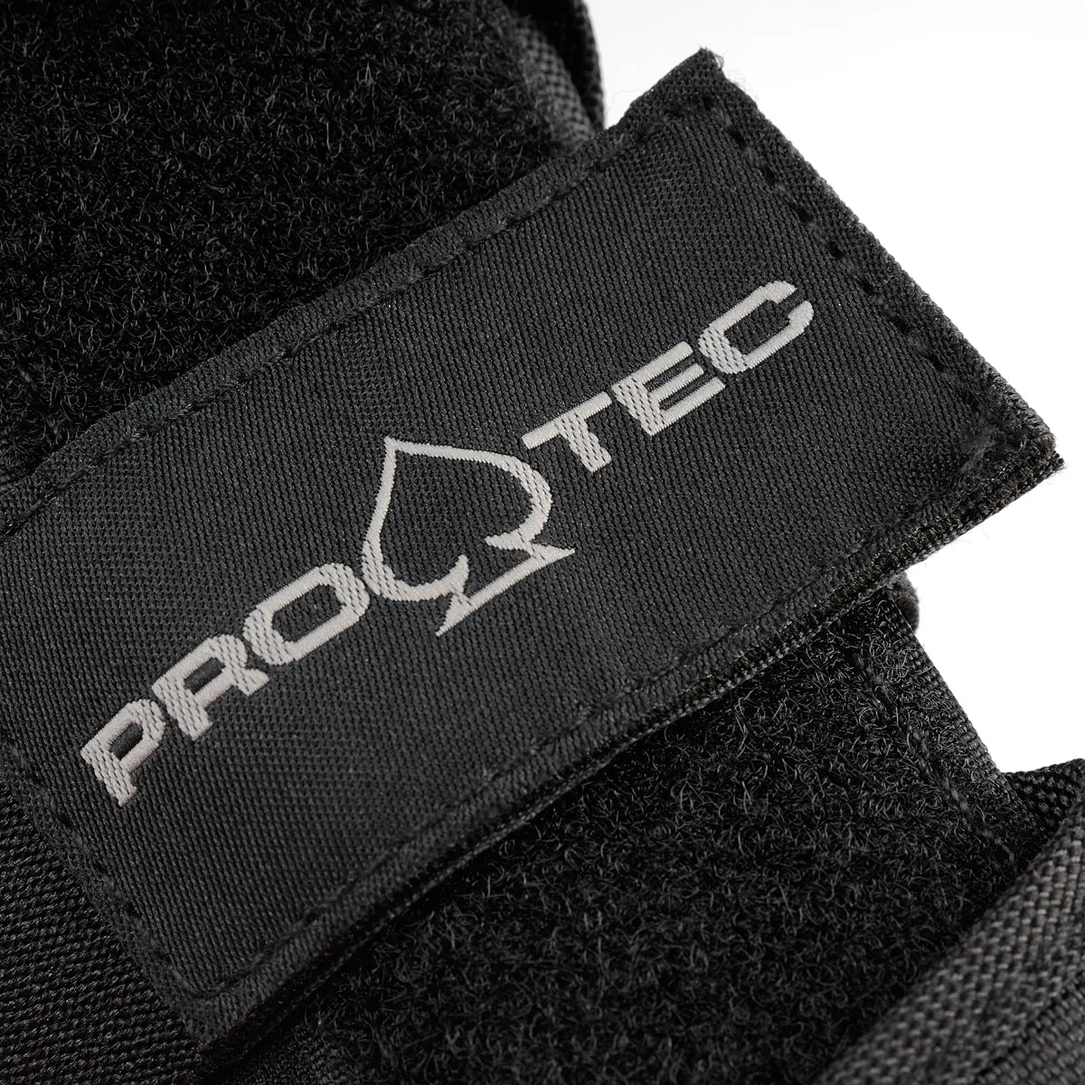 Close-up of a Pro-Tec logo on a black wrist guard