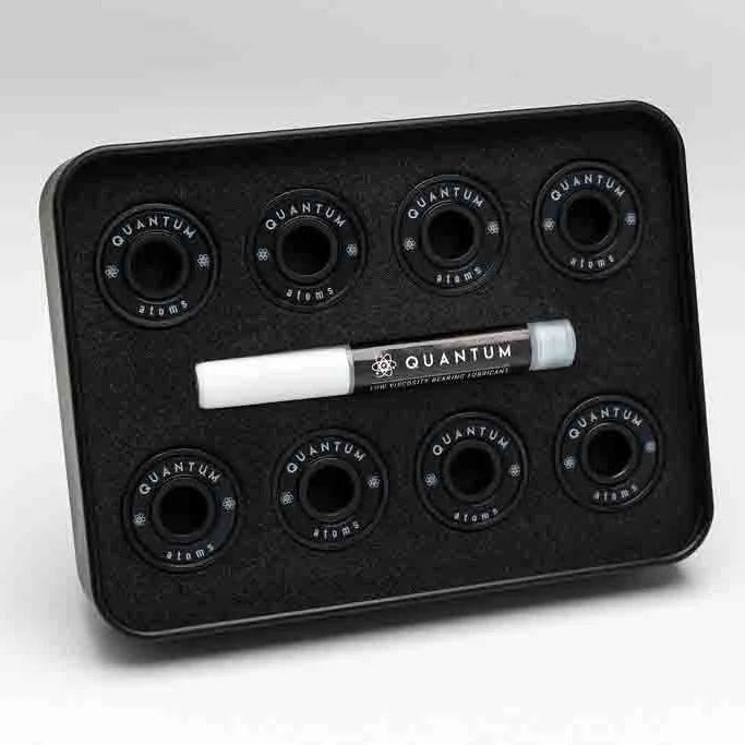 Black tray with Quantum branding containing six black circular components and a white marker on a light gray background.