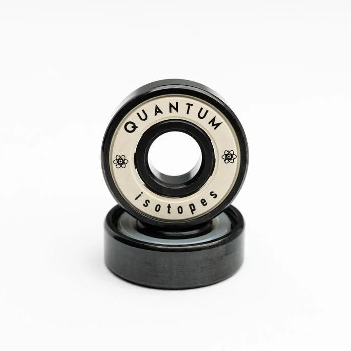Two black bearings with 'Quantum Isotopes' branding on a white background