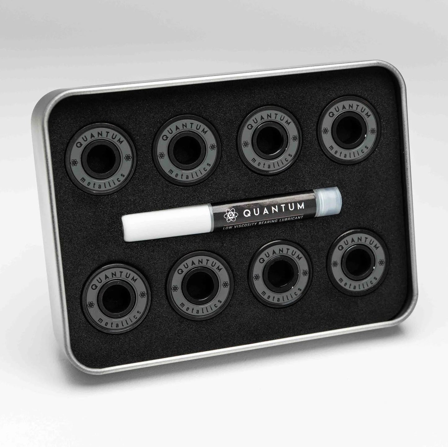 Set of Quantum skateboard bearings in a metal tray on a white background