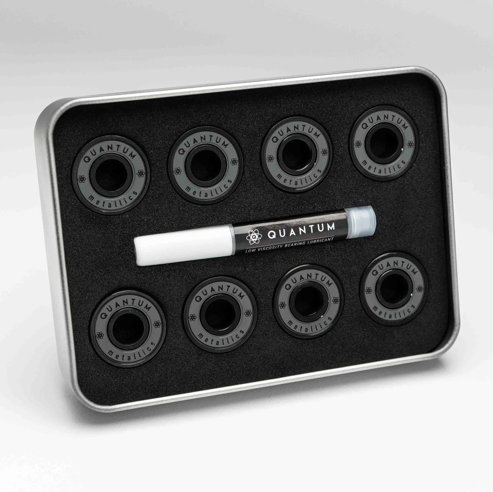 Set of Quantum skateboard bearings in a metal tray on a white background