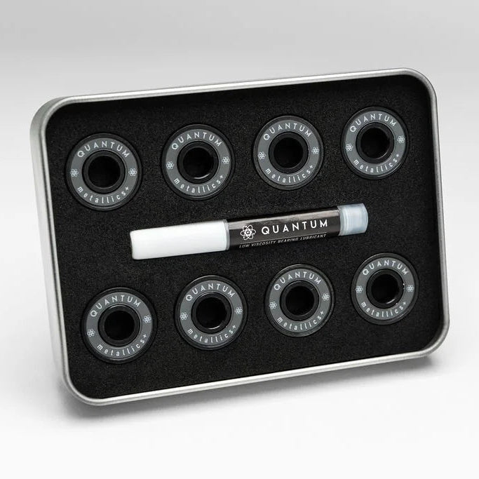 Set ofQuantum skateboard bearings on a black tray with a white background