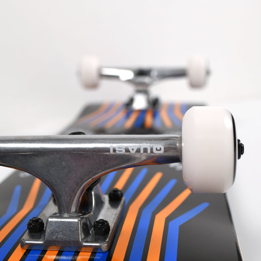 Close-up of a skateboard with a colorful deck and visible trucks on a white background