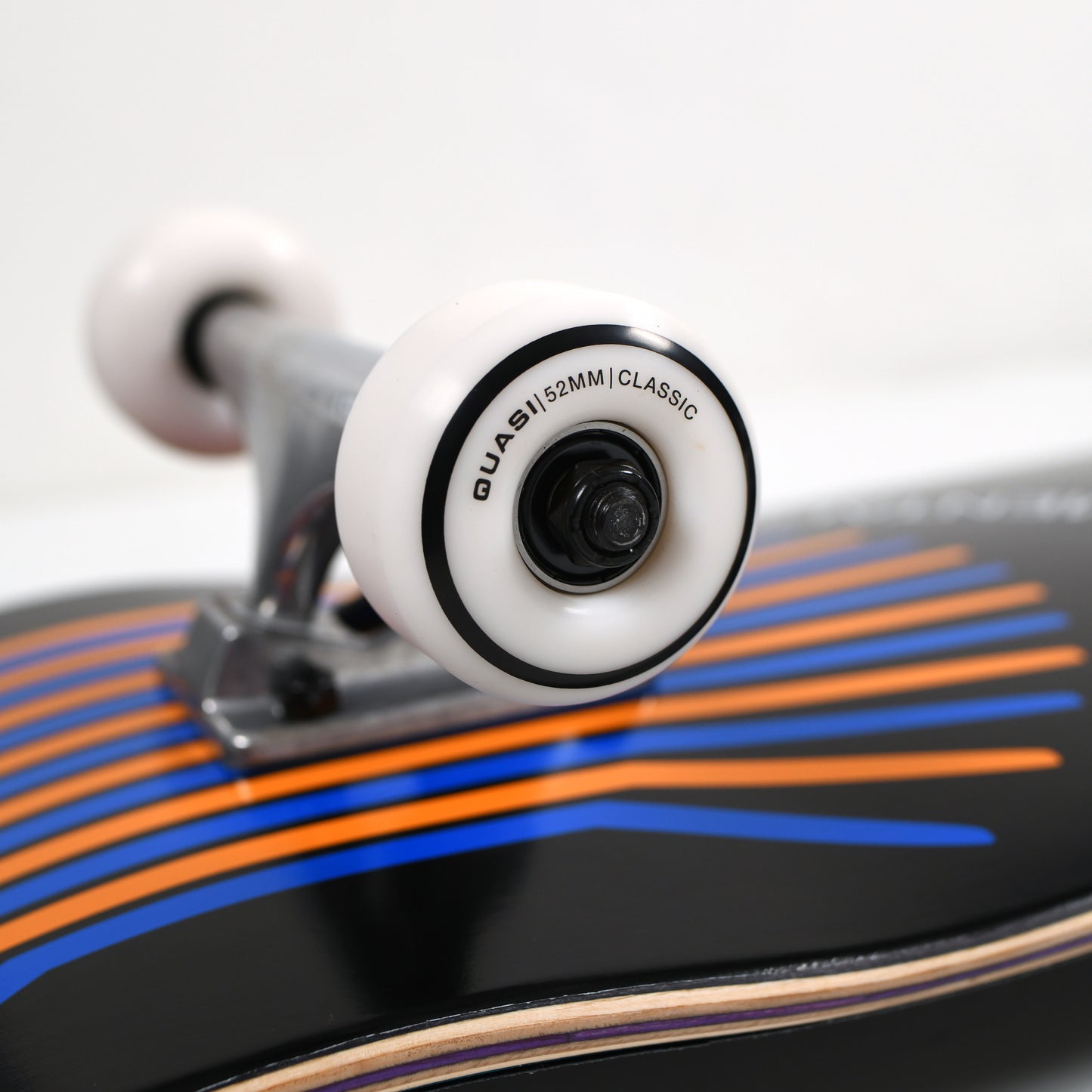 Close-up of a skateboard with a focus on the wheel and deck design.