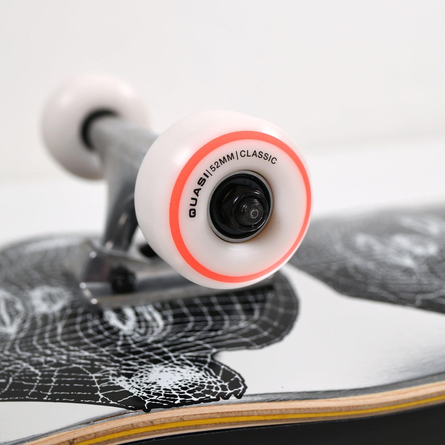 Close-up of a skateboard with a focus on the wheel and deck design.
