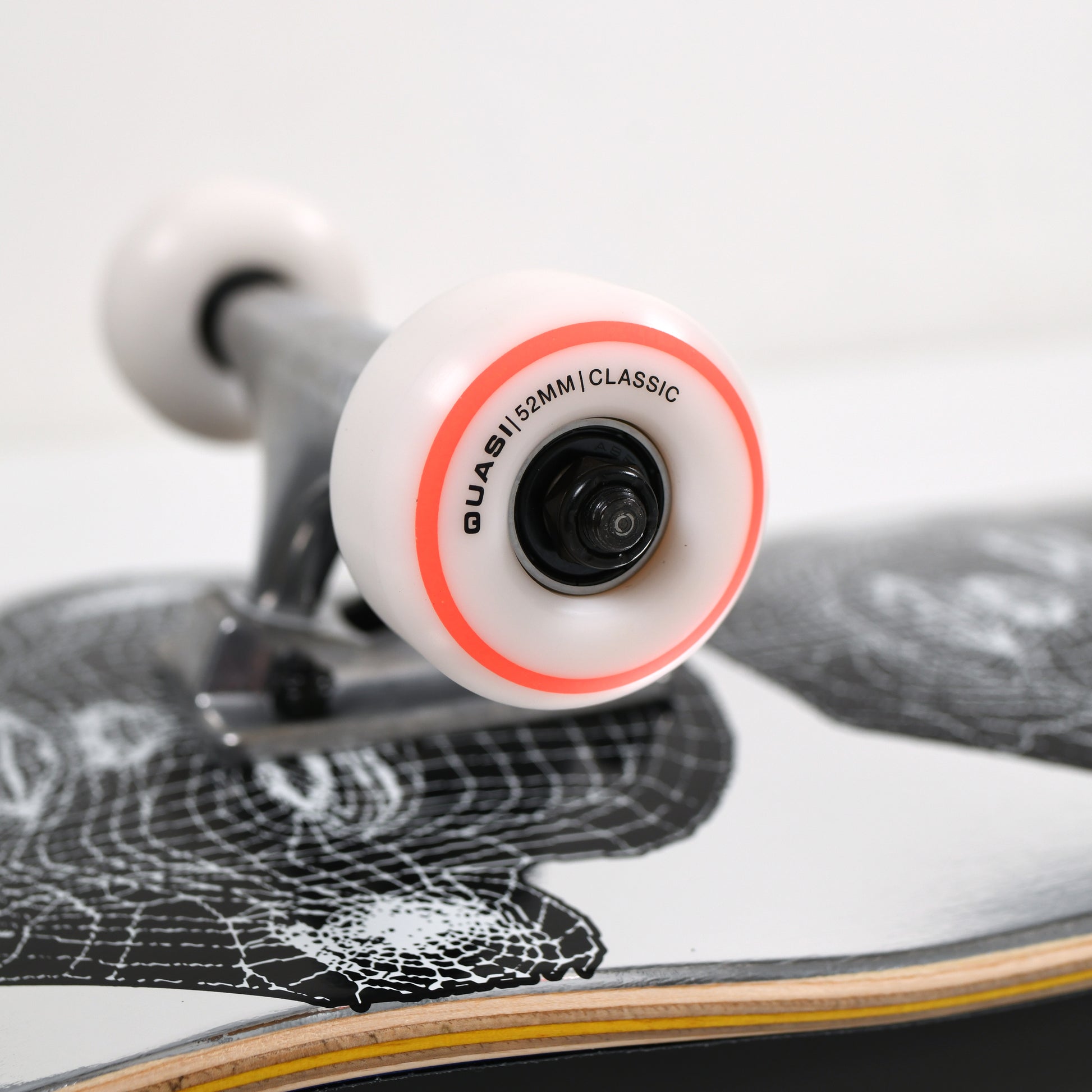 Close-up of a skateboard with a focus on the wheel and deck design.