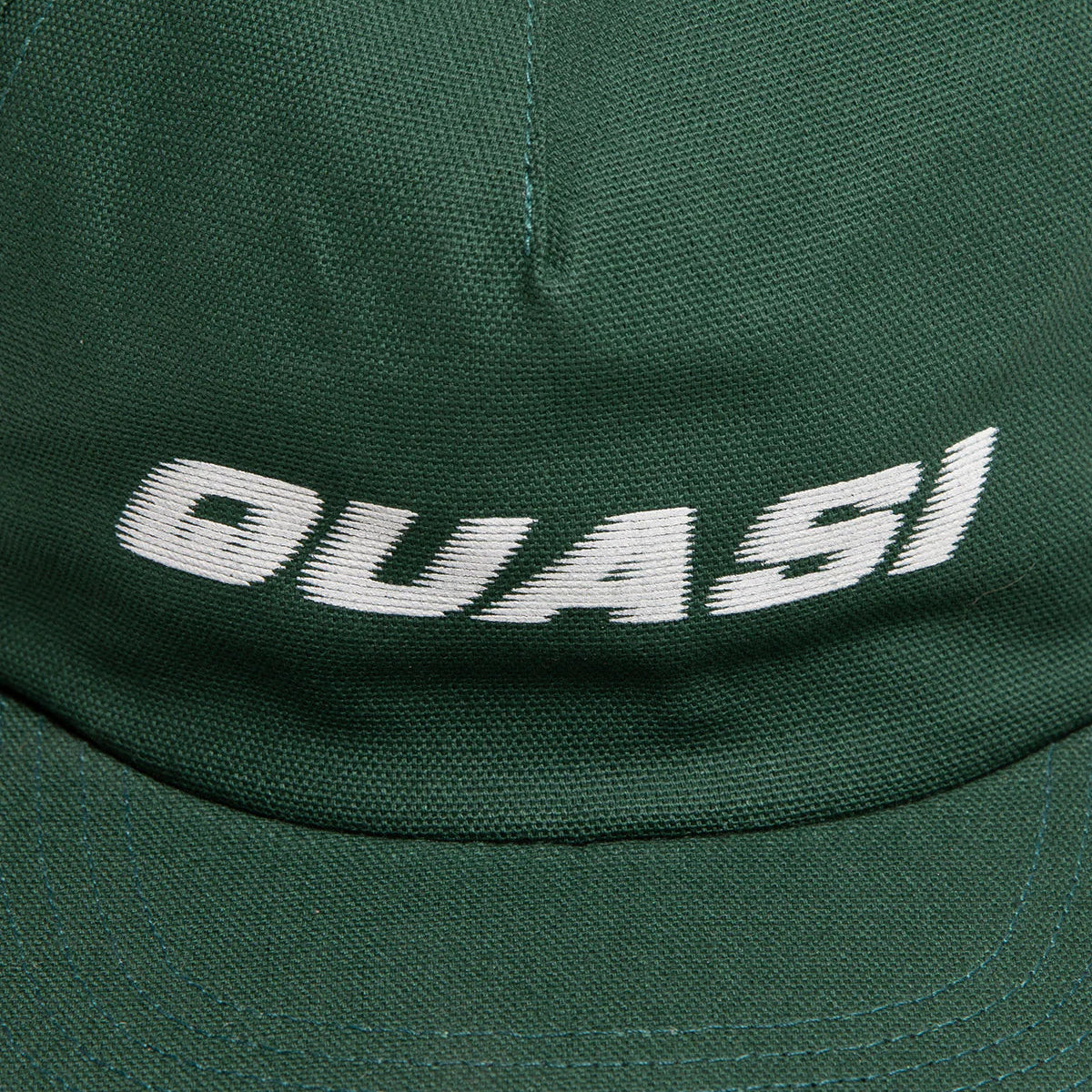 Green cap with 'DUASI' branding on a close-up view