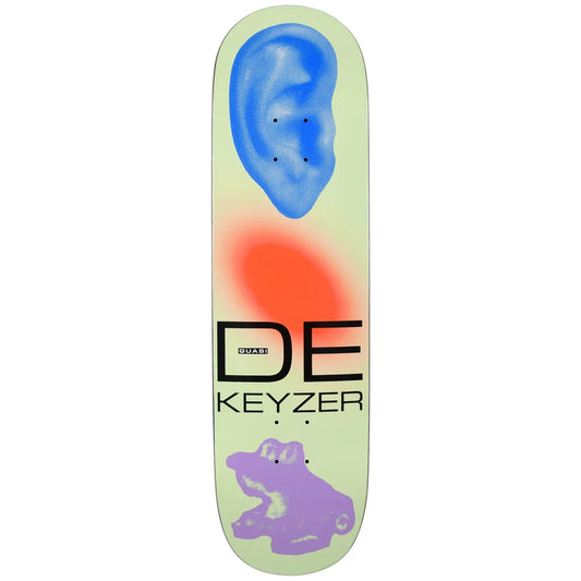 A skateboard deck featuring a pale mint green background with a blue ear graphic at the top, a red-orange glow shape in the center, a purple frog graphic at the bottom, and the text 'DE KEYZER' printed in black.