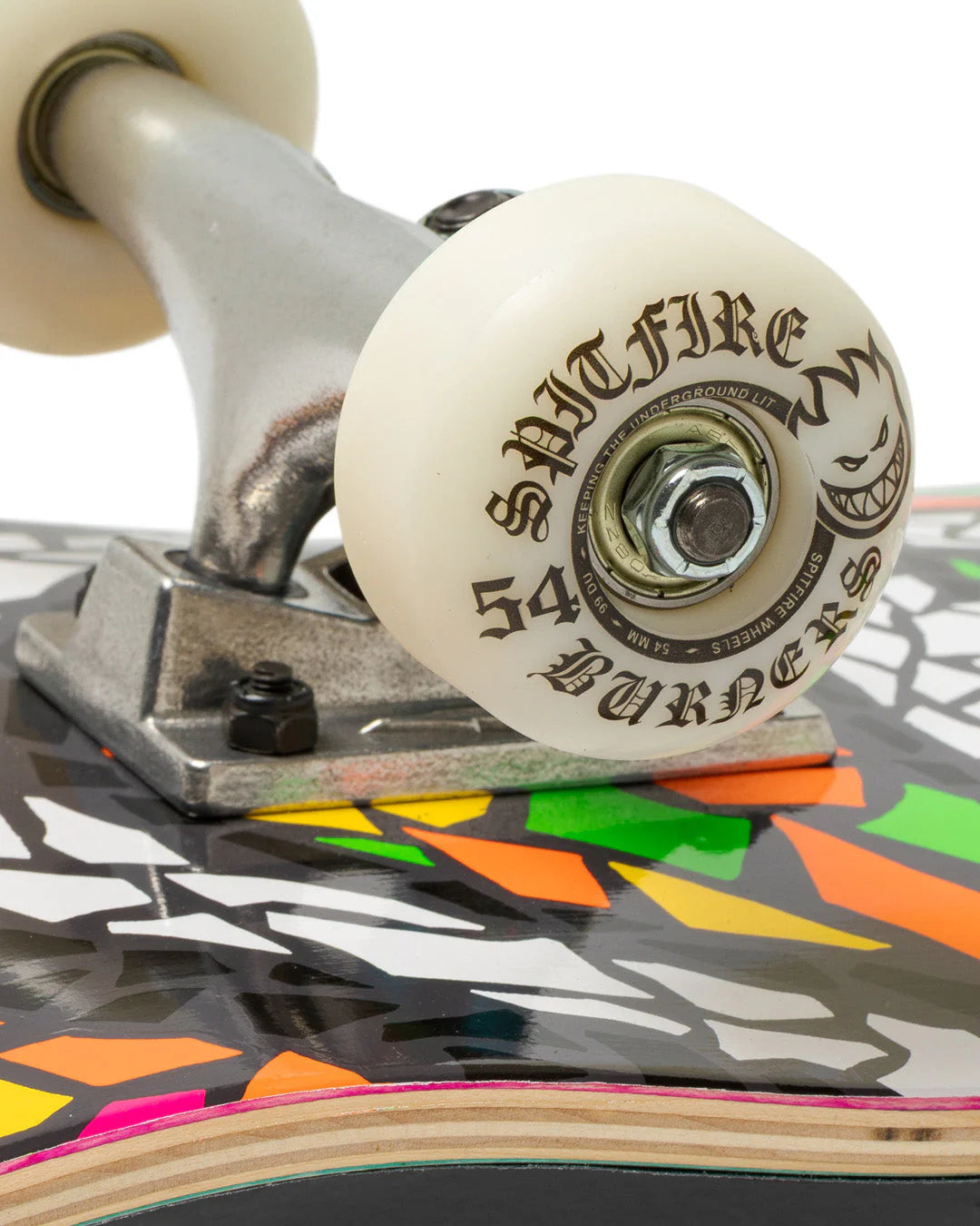 Close-up of a skateboard with Spitfire wheels on a colorful background