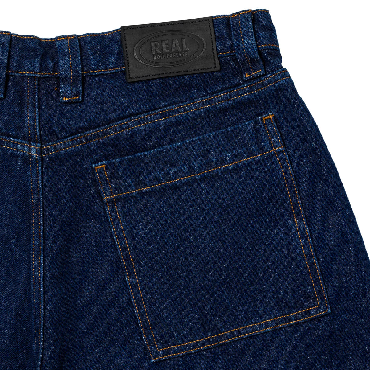 Close-up of blue jeans with a visible brand label on a white background