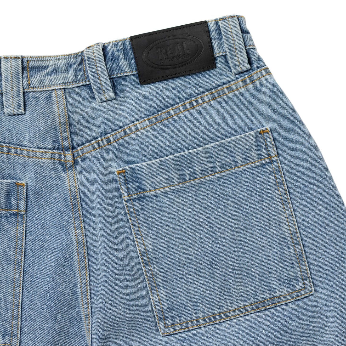 Close-up of blue denim jeans with a brand label on the pocket.
